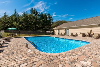 A small pool surrounded by a brick patio.
